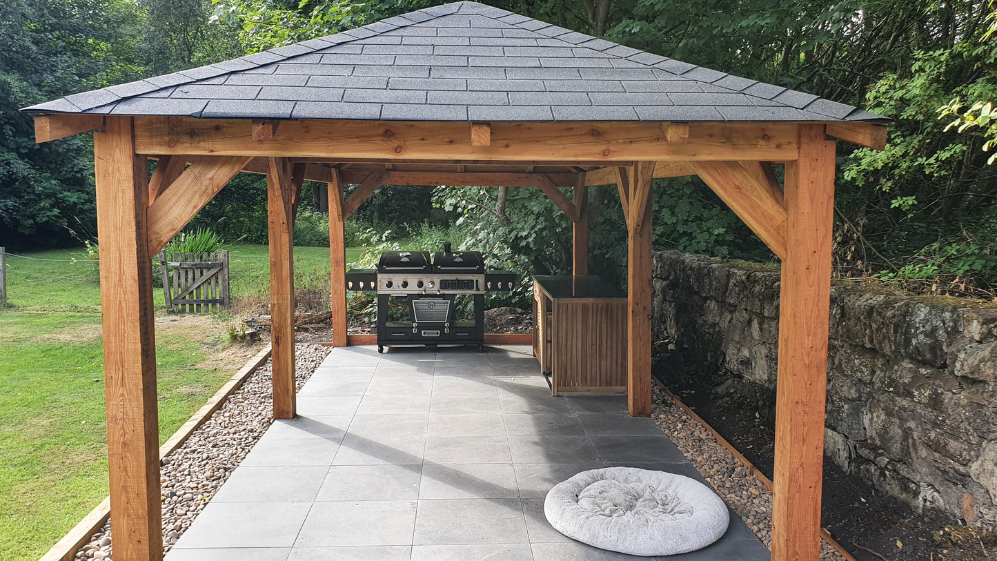 End view of a larch garden gazebo showing the full length with a bbq underneath