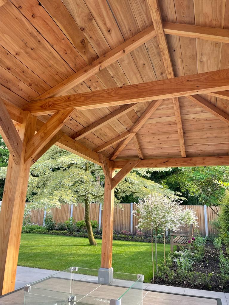 Warm looking timber boards on the inside of the gazebo showing roof structure 